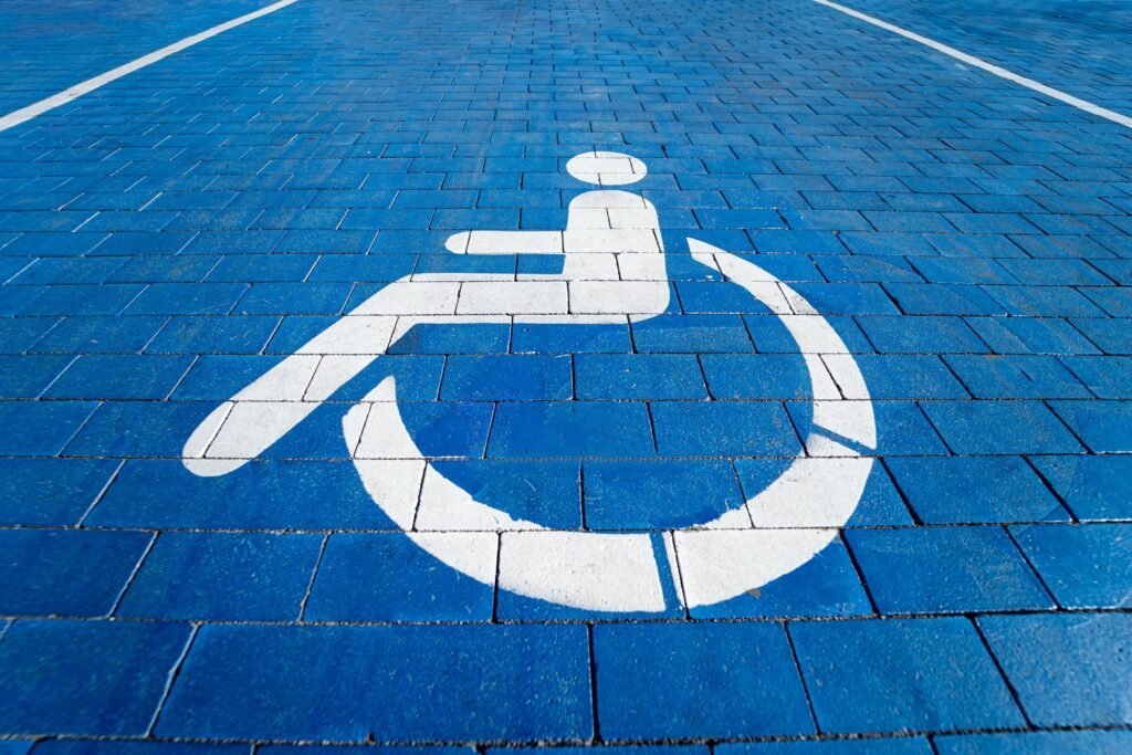 Accessible parking space marked with a white wheelchair symbol on a blue background, designed by a contractor specializing in remodeling.